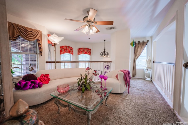 living room with ceiling fan and carpet