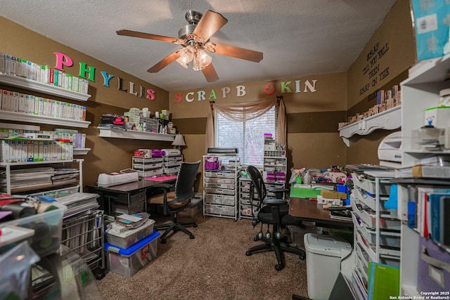 carpeted office space featuring ceiling fan and a textured ceiling