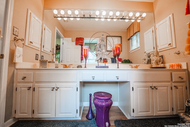 bathroom featuring hardwood / wood-style flooring, vanity, and a healthy amount of sunlight