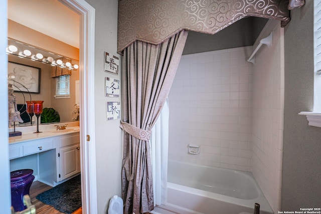 bathroom with shower / tub combo with curtain and vanity