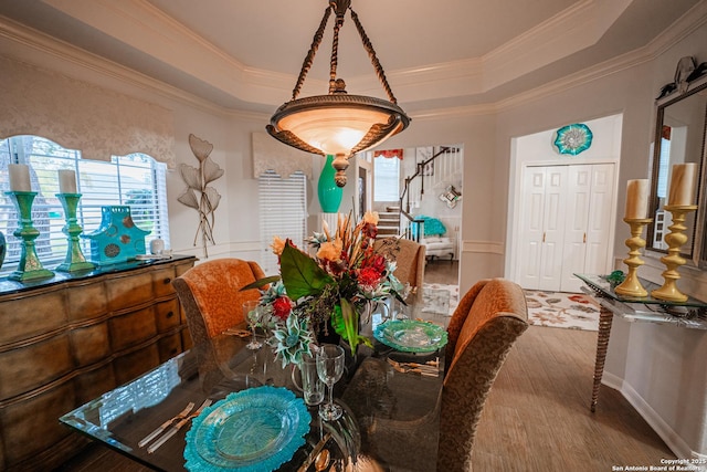 dining room with crown molding and a raised ceiling