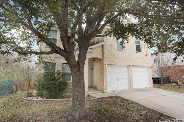 view of front facade with central air condition unit and a garage