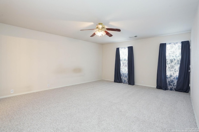 spare room with ceiling fan and light colored carpet