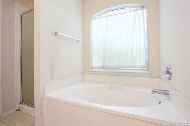 bathroom featuring shower with separate bathtub