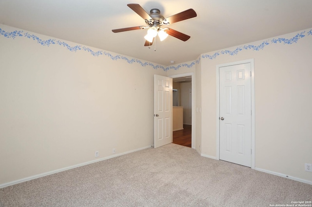 unfurnished bedroom with ceiling fan and light colored carpet