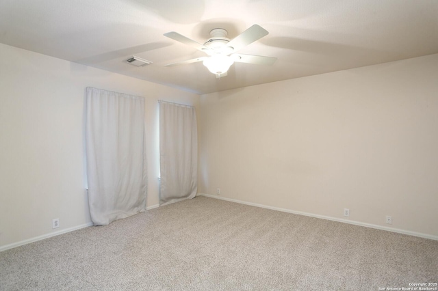 carpeted spare room featuring ceiling fan