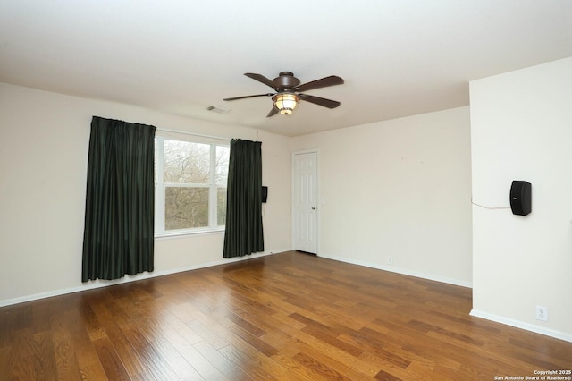 unfurnished room with ceiling fan and hardwood / wood-style flooring