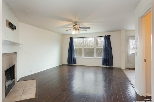 unfurnished living room with a fireplace, ceiling fan, and light hardwood / wood-style flooring