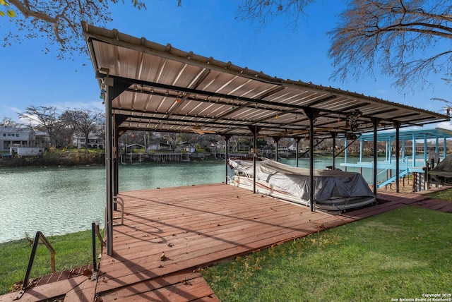 dock area with a yard and a water view