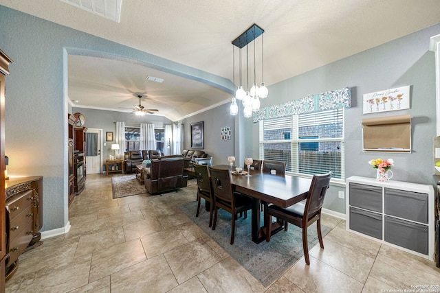 dining area with ceiling fan and crown molding