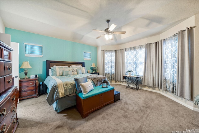 bedroom with vaulted ceiling, a textured ceiling, light colored carpet, and ceiling fan