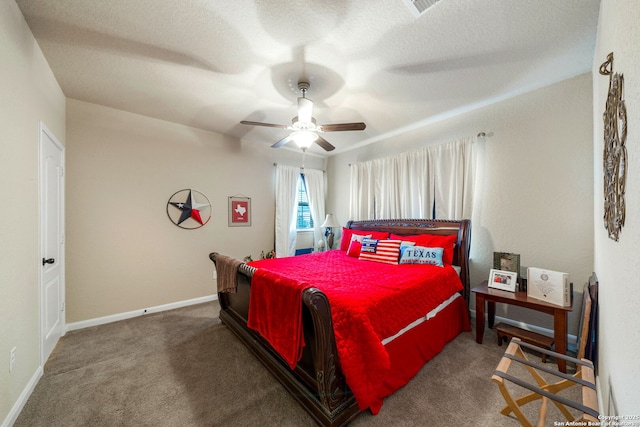 carpeted bedroom featuring a textured ceiling and ceiling fan