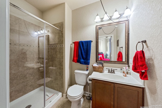 bathroom featuring an enclosed shower, vanity, and toilet