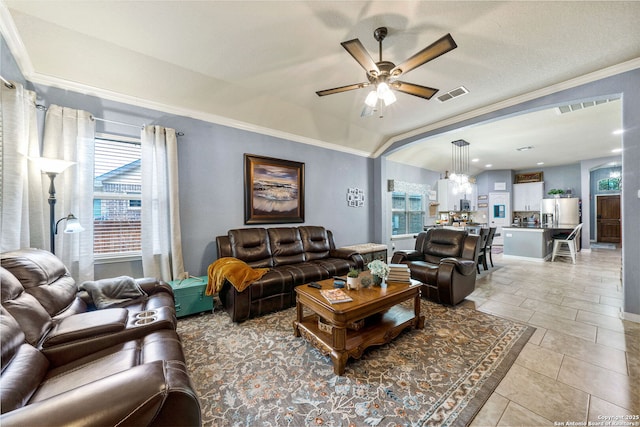 tiled living room featuring ceiling fan, vaulted ceiling, and crown molding