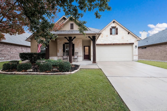 view of front of house with a garage, covered porch, and a front lawn