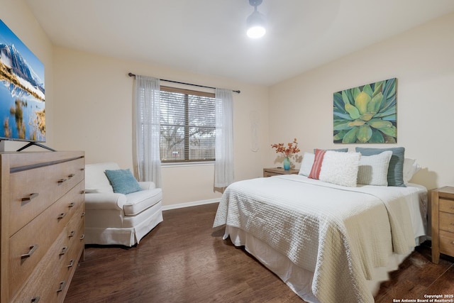 bedroom with dark hardwood / wood-style floors