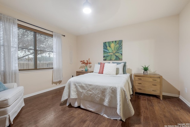 bedroom with dark hardwood / wood-style floors