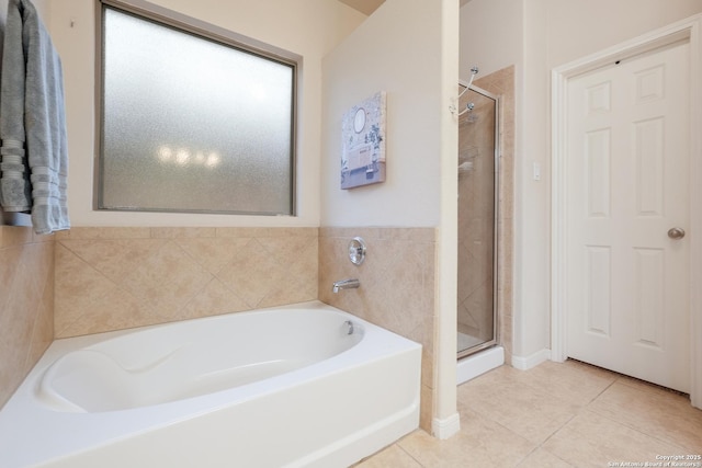 bathroom featuring tile patterned flooring and separate shower and tub