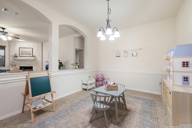 dining area with ceiling fan, a fireplace, and carpet flooring