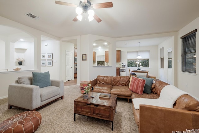 carpeted living room featuring ceiling fan