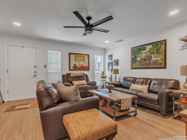 living room featuring light hardwood / wood-style floors, ornamental molding, and ceiling fan