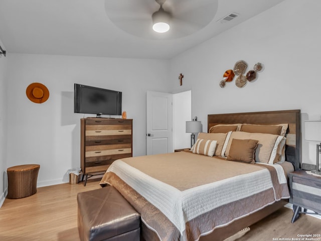 bedroom with ceiling fan, lofted ceiling, and wood-type flooring