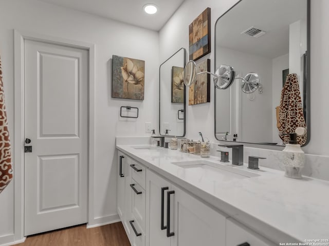 bathroom featuring vanity and hardwood / wood-style floors