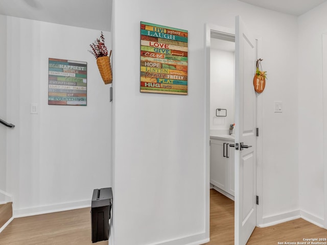 corridor with light hardwood / wood-style flooring