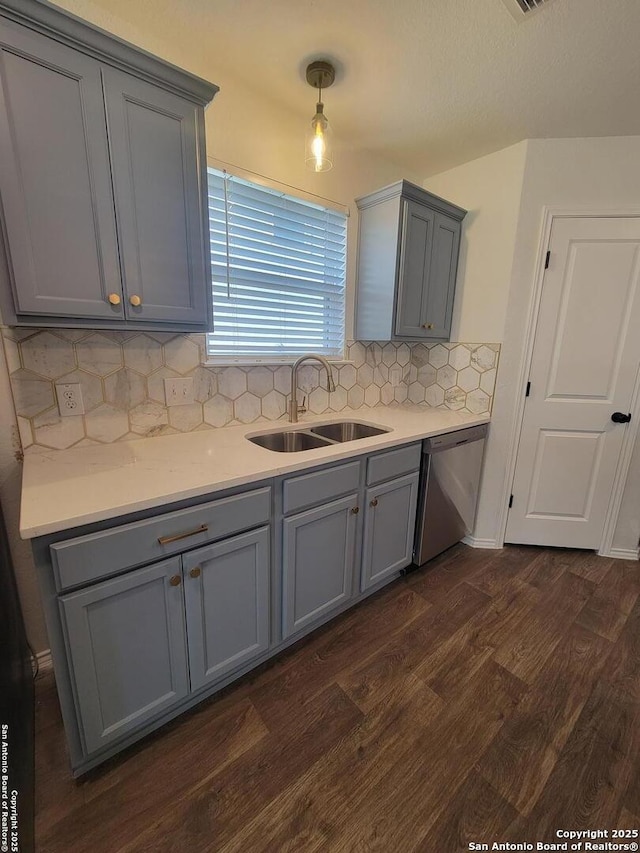 kitchen with dishwasher, pendant lighting, gray cabinets, backsplash, and sink