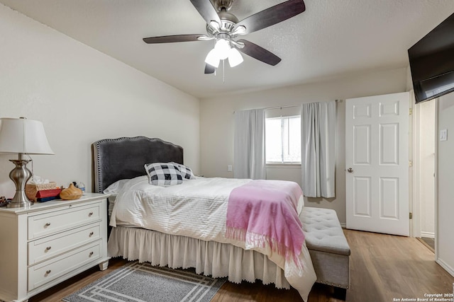 bedroom featuring ceiling fan and light wood-type flooring