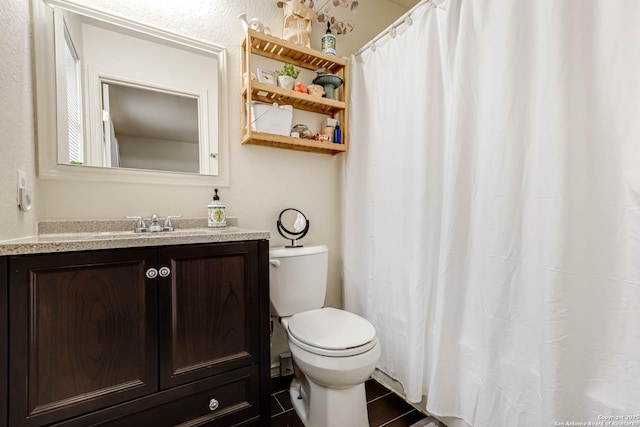 bathroom featuring toilet and vanity