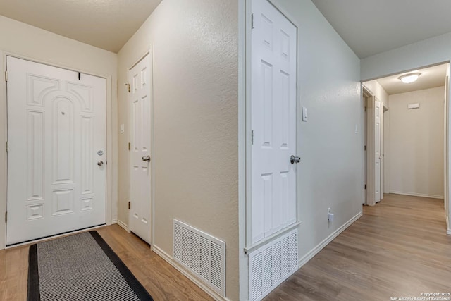 corridor with light wood-type flooring