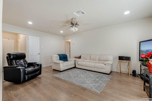 living room with ceiling fan and hardwood / wood-style flooring