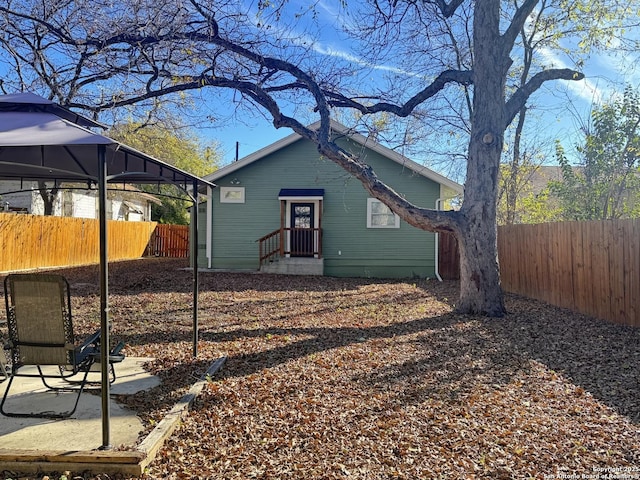 back of house with a gazebo