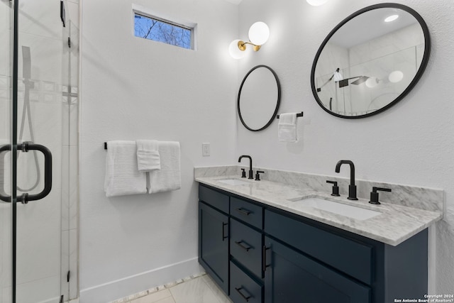 bathroom with an enclosed shower, vanity, and tile patterned floors