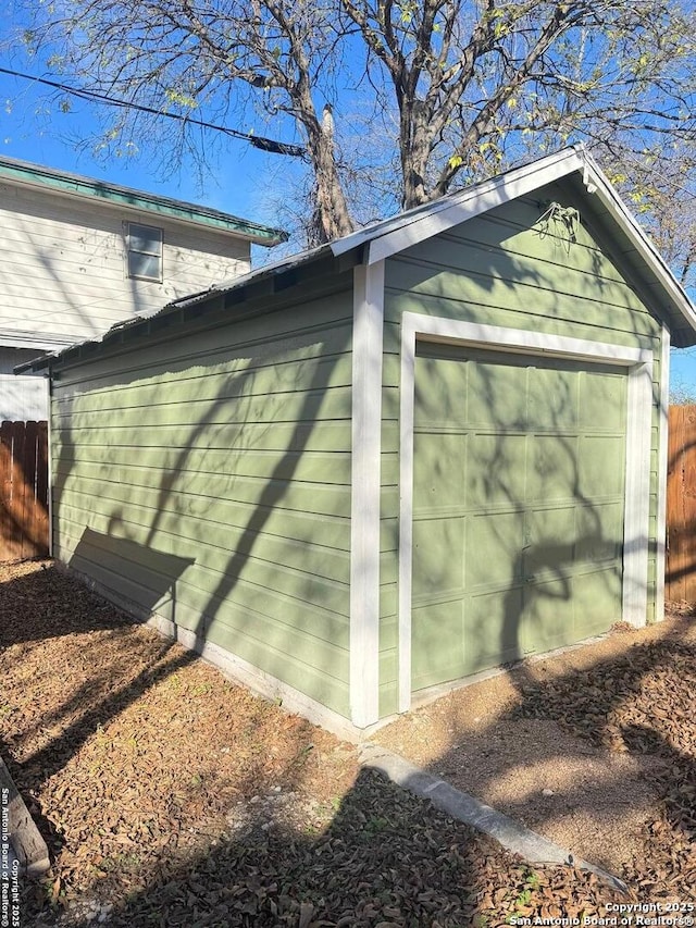 view of side of home featuring a garage and an outdoor structure