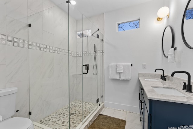 bathroom featuring toilet, tile patterned flooring, a shower with shower door, and vanity