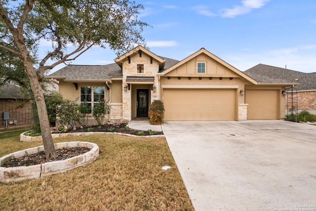 view of front of property with a garage and a front lawn