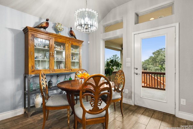 dining room featuring lofted ceiling and a chandelier