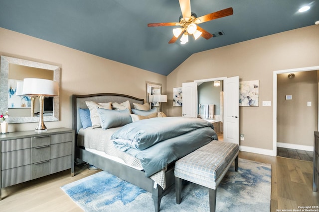 bedroom with ceiling fan, light wood-type flooring, and vaulted ceiling