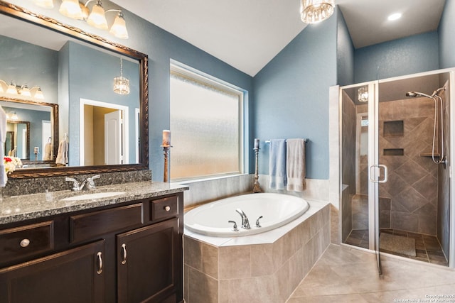 bathroom featuring separate shower and tub, tile patterned flooring, lofted ceiling, and vanity