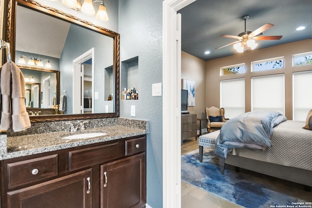 bedroom with ceiling fan, light hardwood / wood-style floors, and sink