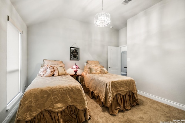 carpeted bedroom with vaulted ceiling and a notable chandelier