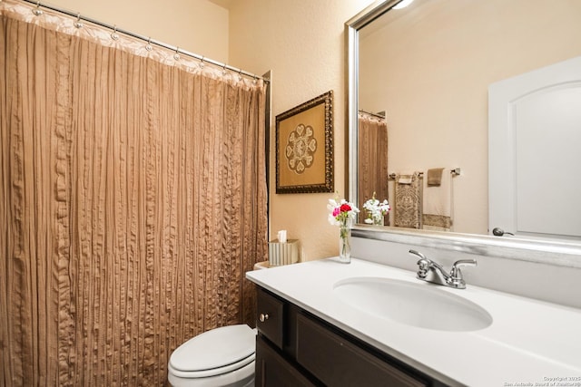 bathroom featuring toilet and vanity