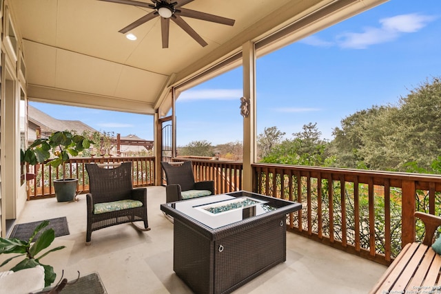 wooden deck with a patio area, ceiling fan, and a fire pit