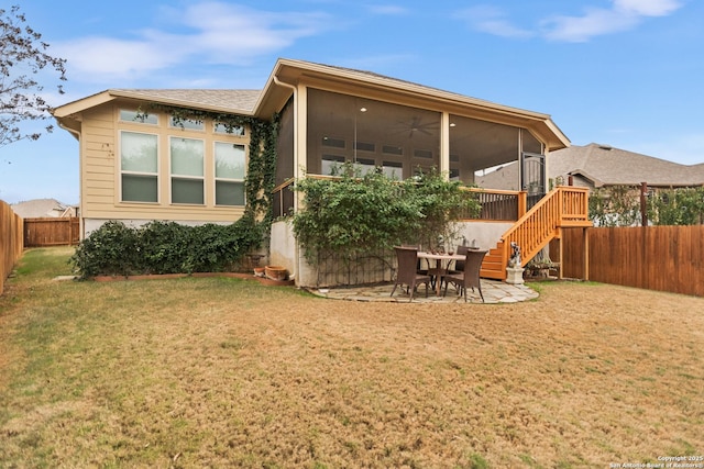 rear view of property featuring a patio area, ceiling fan, and a lawn