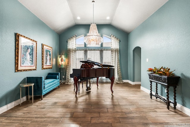 miscellaneous room with vaulted ceiling and a chandelier