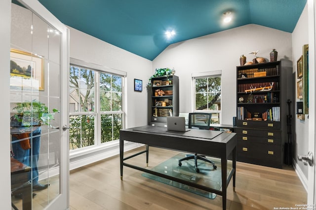 office space featuring light hardwood / wood-style floors and lofted ceiling