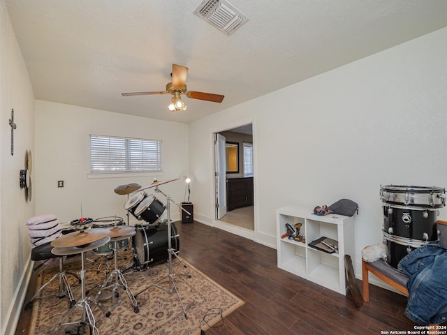 interior space with dark wood-type flooring, a textured ceiling, and ceiling fan