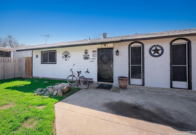 single story home featuring a front yard and a patio